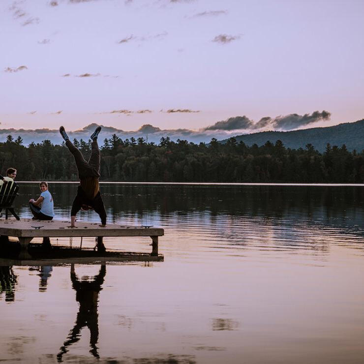 Paul Smith's student doing handstand on the dock